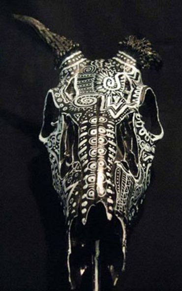 Adorned deer skull with deformed horn, painted with organic and geometric designs