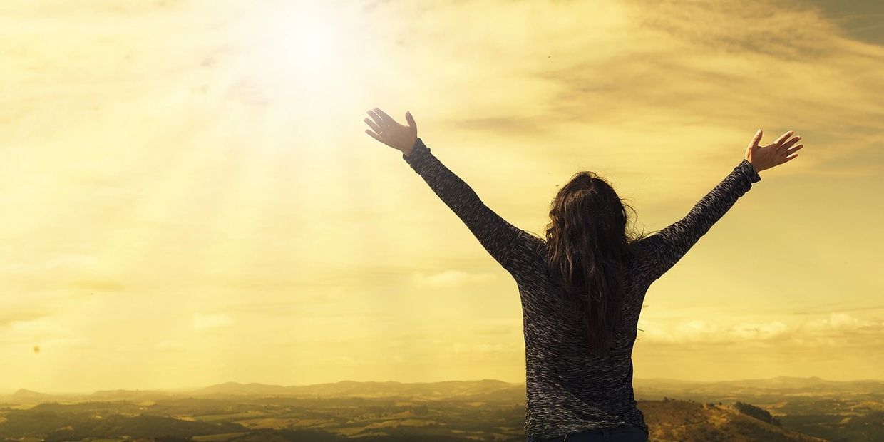 Hands raised to sunrise