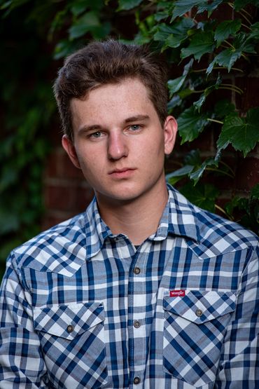 Brown-haired boy posing for pictures. Logan | HUHS Senior | Class of 2026