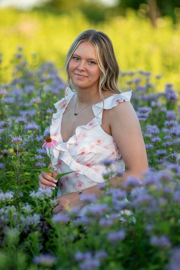 Girl with golden blonde hair among wildflowers Abby | HUHS Senior | Class of 2026