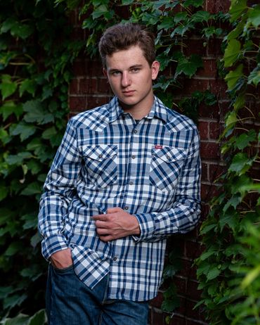 Brown-haired boy posing for pictures. Logan | HUHS Senior | Class of 2026