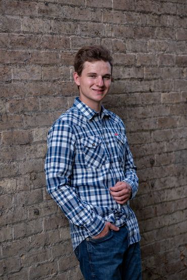 Brown-haired boy posing for pictures. Logan | HUHS Senior | Class of 2026