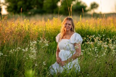 Girl with golden blonde hair among wildflowers Abby | HUHS Senior | Class of 2026