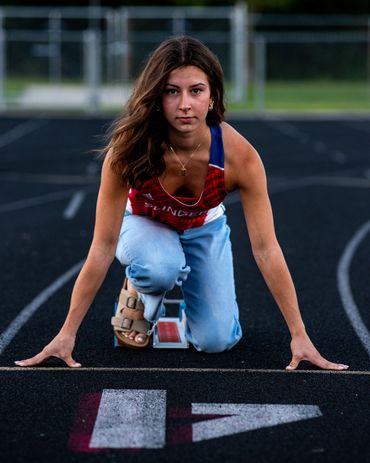 Brown-haired girl in track uniform. Lea | SHS Senior | Hurdles | Class of 2026