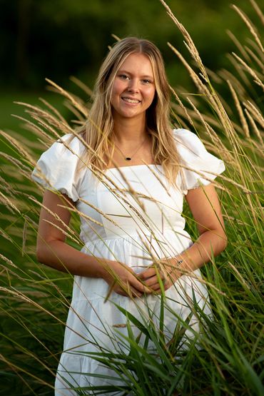 Girl with golden blonde hair among wildflowers Abby | HUHS Senior | Class of 2026