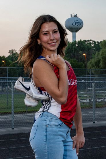 Brown-haired girl in track uniform. Lea | SHS Senior | Hurdles | Class of 2026