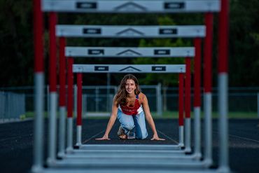 Brown-haired girl in track uniform. Lea | SHS Senior | Hurdles | Class of 2026