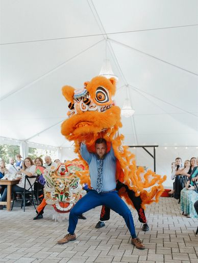 Groom doing Chinese lion dance at wedding reception