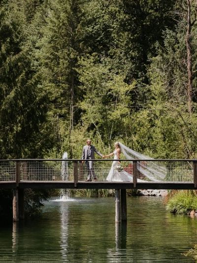 A bridge crossing the water and forest in Snohomish County Washington for bride and groom