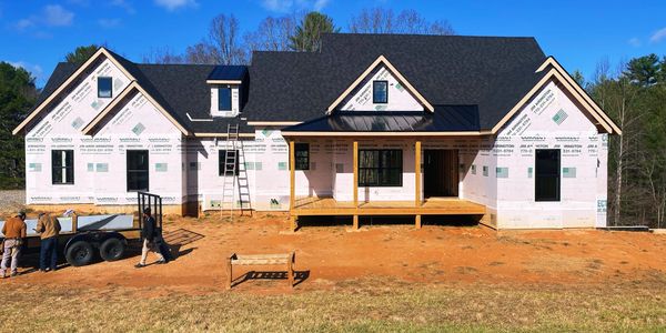 Home with custom architectural shingle and standing seam metal roof