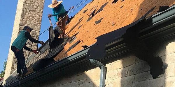 Roofers tearing off a roof