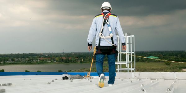 Commercial roofer on roof