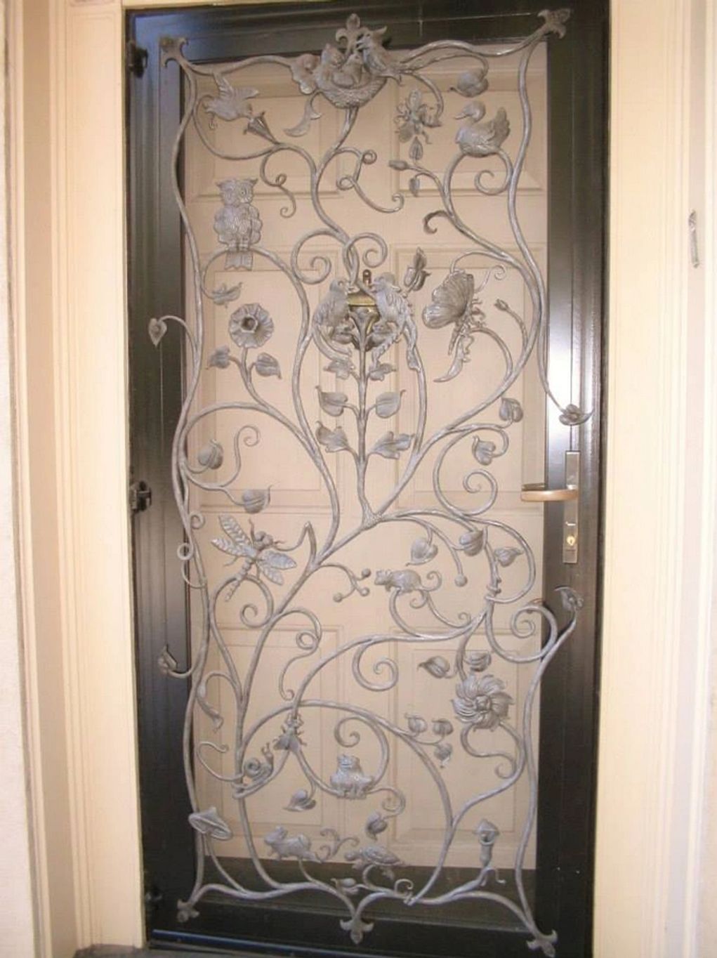 Hand forged custom door grille with forged small animal creatures. Working with Pomeroy and Company