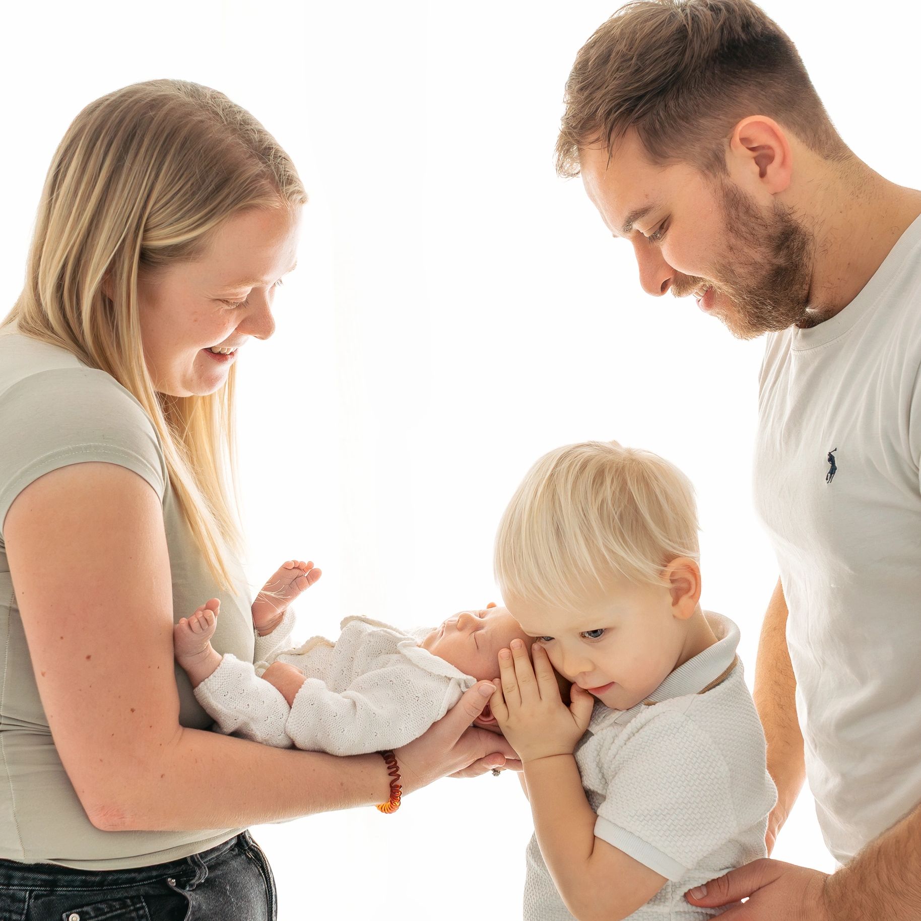 Joyful family moment with parents and children bonding tenderly.
