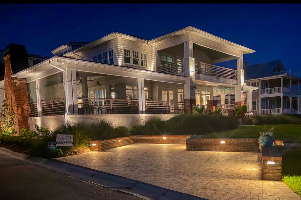 Large modern house lit up at night.