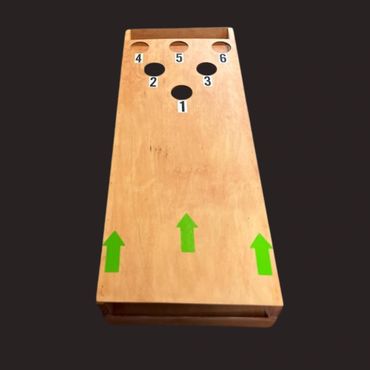 Wooden cornhole board with numbered holes and green arrows.