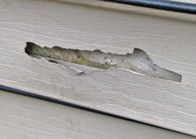 Pressure washing damage on vinyl Siding from High-Pressure Water