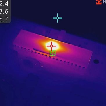Thermal image showing heat concentration on an electronic device.