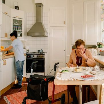 Nurse or Personal Support worker washing dishes for patient or making them lunch