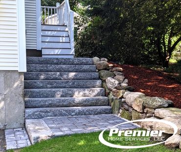 Ideal paver landings with granite steps and stone retaining wall in Littleton MA