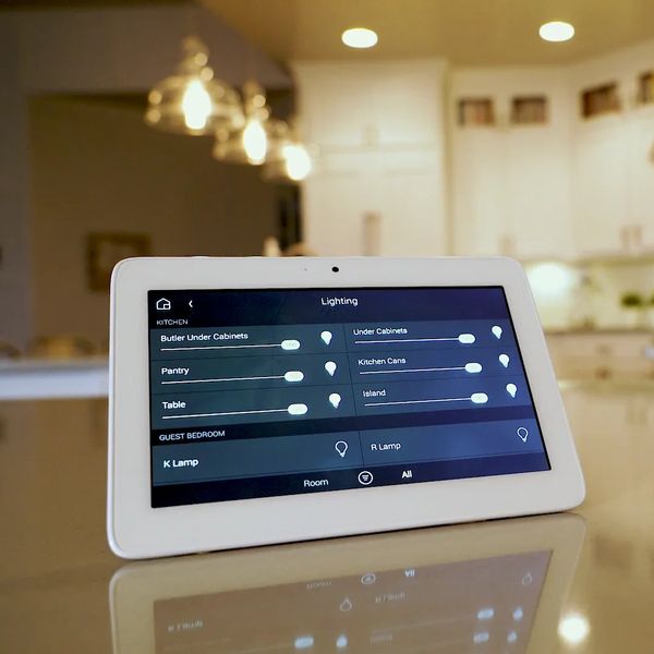 Tablet displaying smart home lighting controls in a modern kitchen.