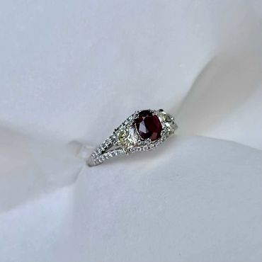 Angled view of the finished red gemstone and diamond ring.