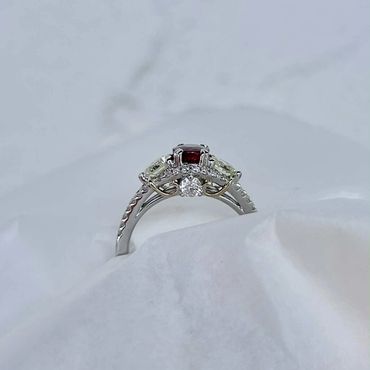 Front view of the finished red gemstone and diamond ring.