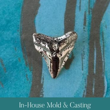 Finished polished metal shark-tooth casting.