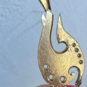 Rough metal casting of a custom fishhook pendant.