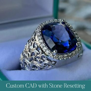 Finished blue gemstone ring in an ornate diamond-accented setting.