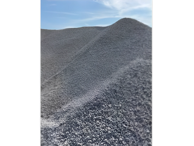 Pile of gray gravel under a blue sky