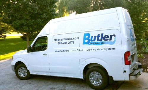 white water treatment service van parked in a driveway with the butler soft water logo on the side