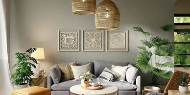 modern decorated living area with cushions, plants, wall hangings, and coffee table.