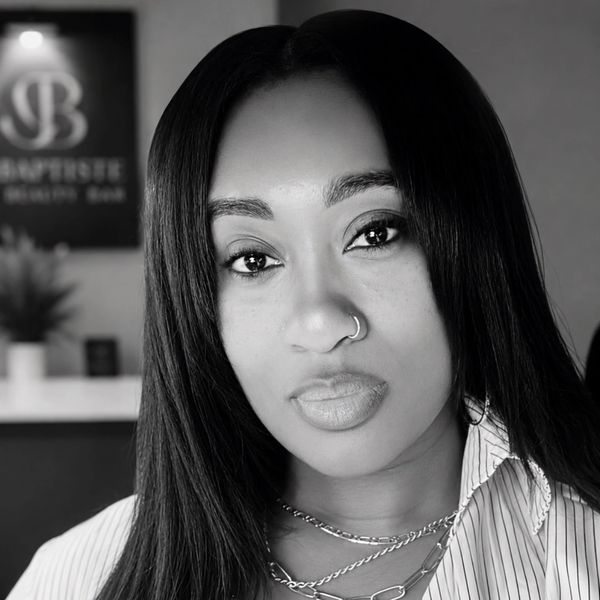 Black and white portrait of a woman with long hair and nose ring.