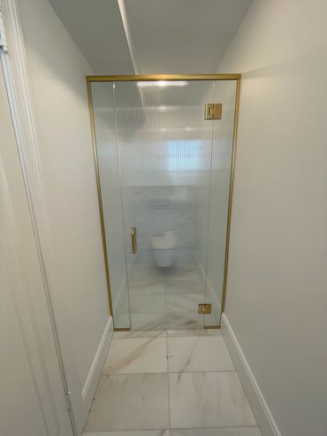 Header Top Glass Shower Enclosure in satin brass / gold color for the hardware