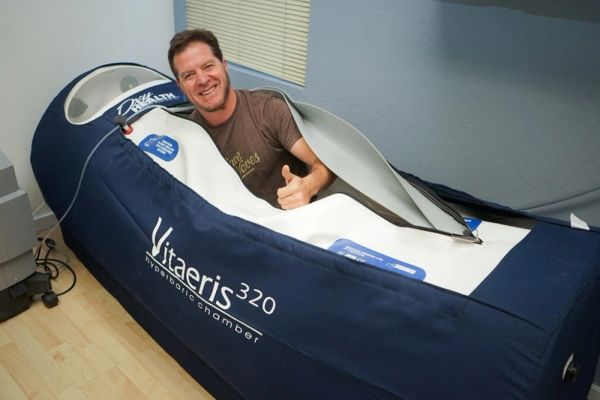 Man smiling inside a Vitateris 320 hydrotherapy chamber.