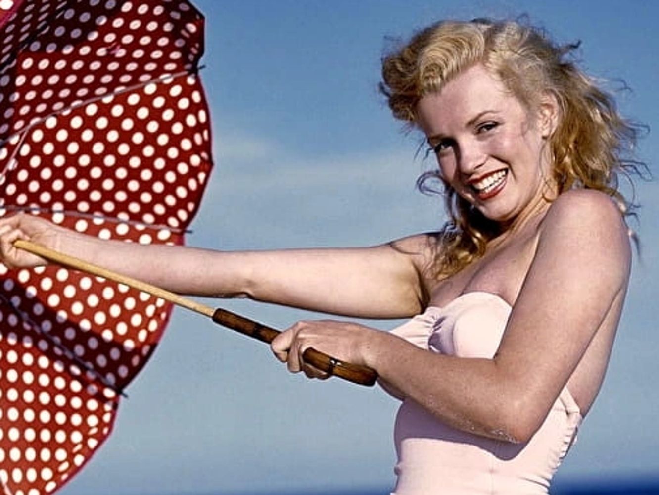 Marilyn Monroe on the beach with red umbrella!