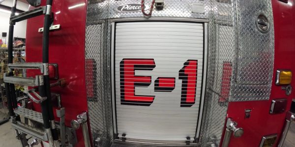 Fire truck door with E-1 label.