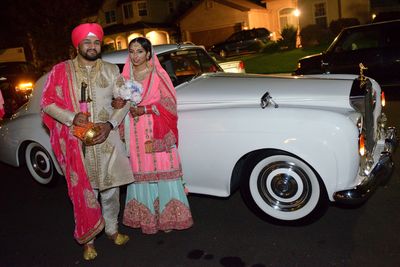 Patrick and Celene Alva celebrating in front of the 1963 Rolls Royce from Antique Limousine