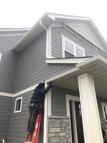 employee working on a gutter repair
