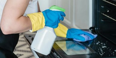 Lady cleaning inside an oven