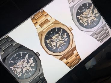 Three stylish Thomas & George watches in silver, gold, and black.