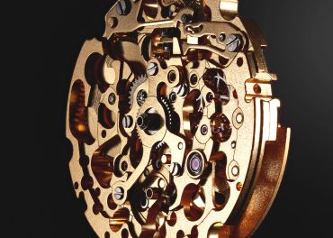Close-up of a gold-colored mechanical watch movement. Miyata 8N4