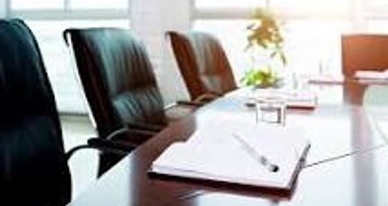 Empty conference room with chairs and a notebook.