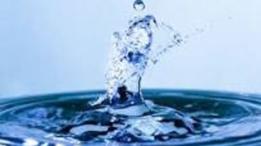 Water droplet splash creating ripples.