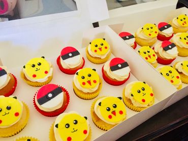 Cupcakes decorated with Pikachu faces and Poké Balls from Pokémon.
