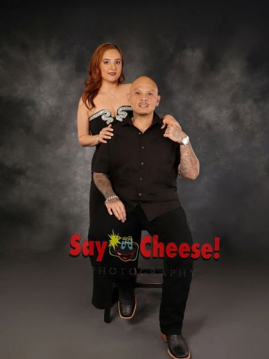 Couple posing for a formal studio portrait.