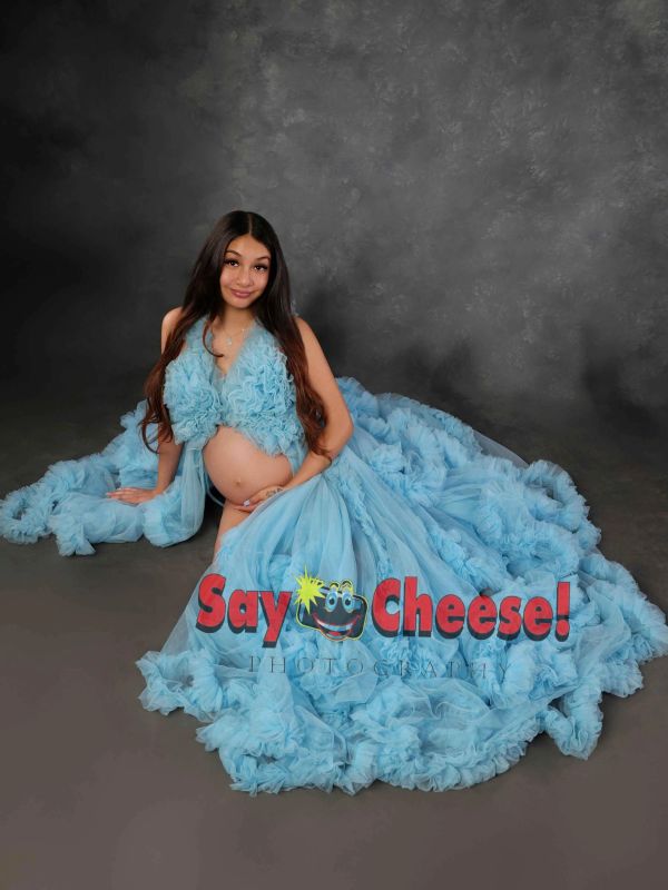 Pregnant woman in a flowing blue gown.