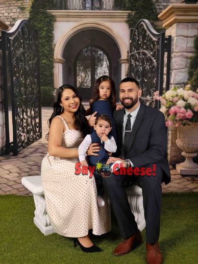 A family of four posing together in a formal setting.