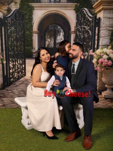 Family portrait with parents and kids in formal attire.